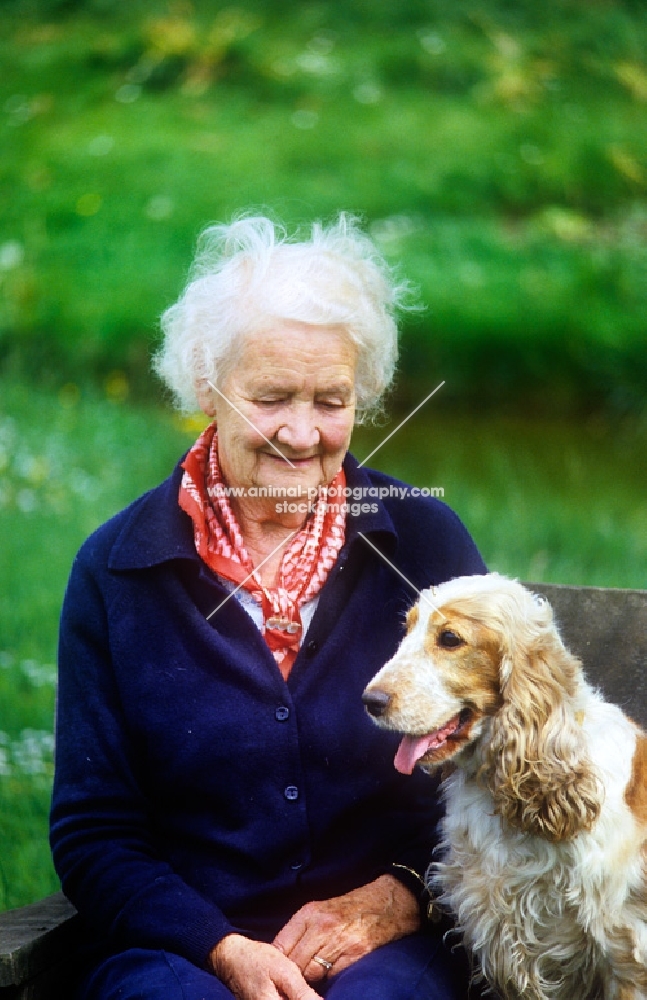 grey haired lady with her cocker spaniel
