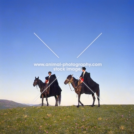Two cossacks riding Kabardine horses Caucasus mountains