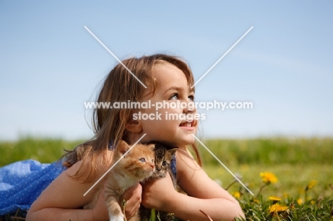 Girl with kitten in summer