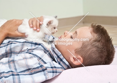 boy lying down with Ragdoll