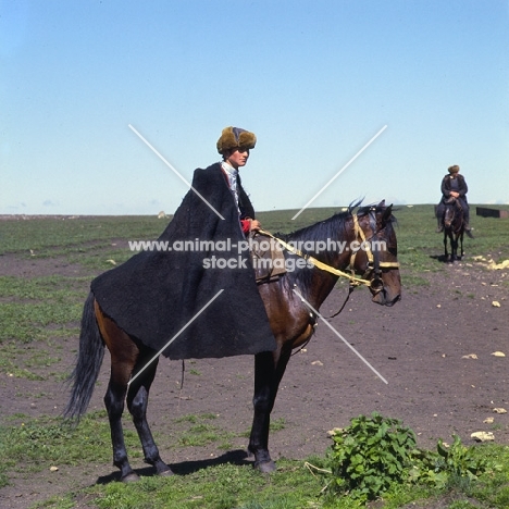 cossack riding Kabardine horse in Caucasus mountains