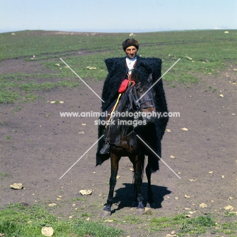 cossack riding Kabardine horse in Caucasus mountains