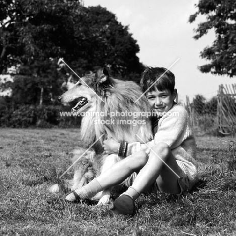 boy holding rough collie