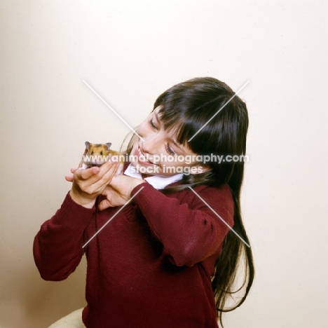 girl holding her pet hamster