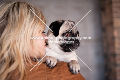 woman holding fawn Pug