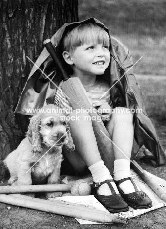 Cocker Spaniel puppy with boy, waiting for rain to stop