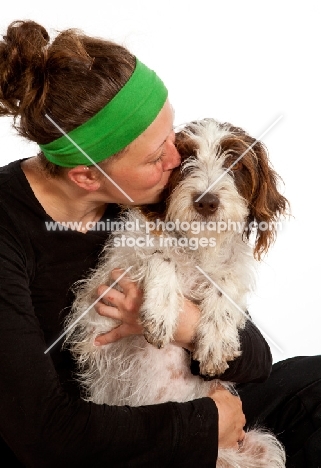 woman kissing her young German Wirehaired Pointer