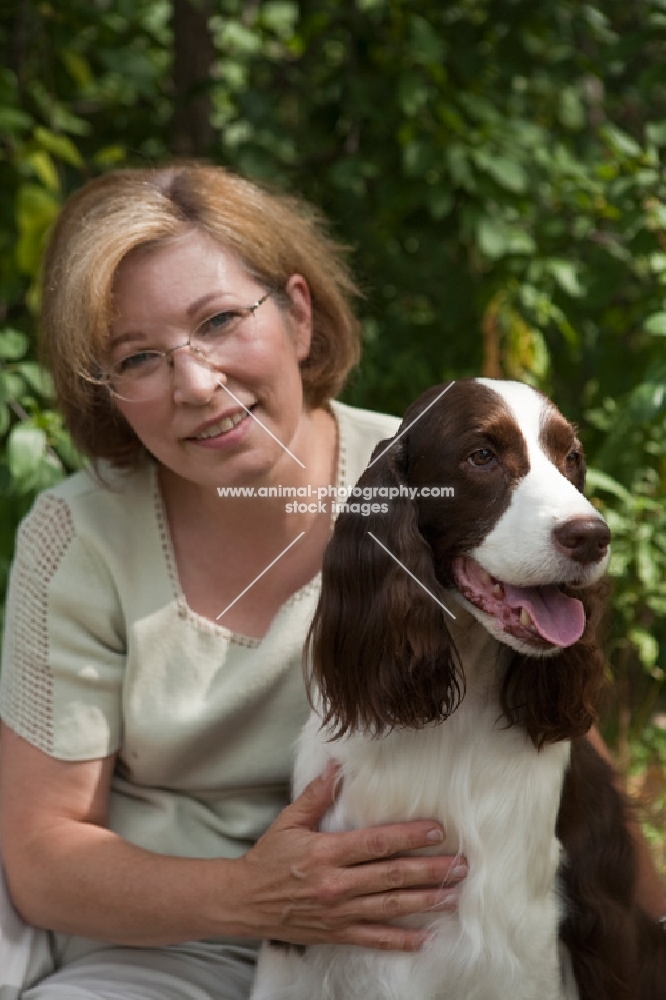 English Springer Spaniel and woman with greenery background