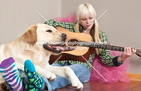 Labrador with girl playing guitar