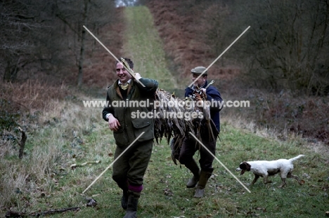 beeters with Pheasants and Partridge slung on a pole taken from the woods.