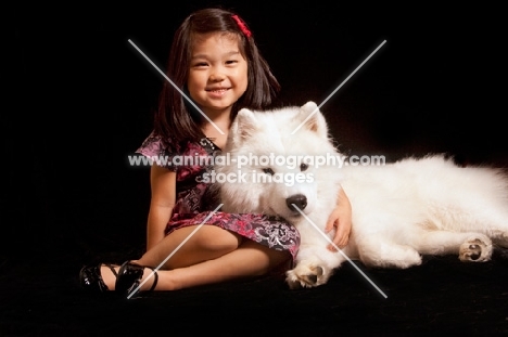 young Samoyed with young girl