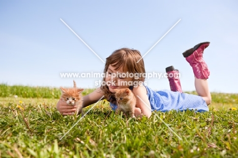 gitl holding two kittens