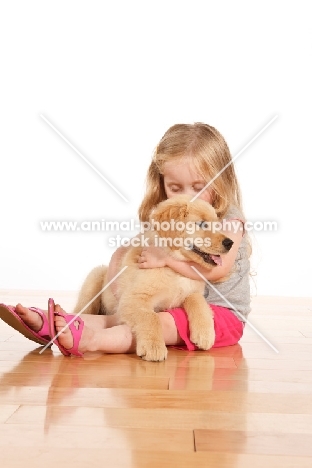 Girl with Golden Retriever puppy