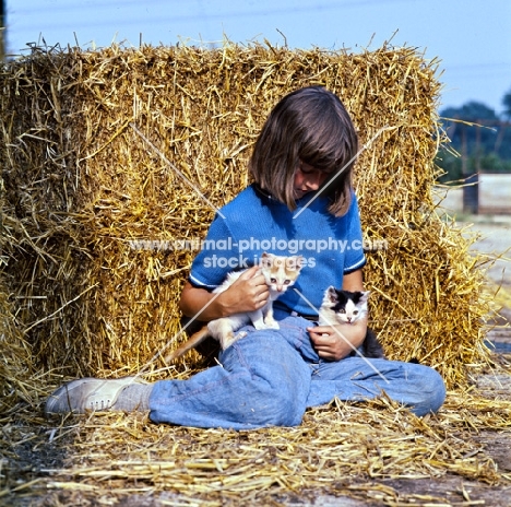 girl holding two kittens