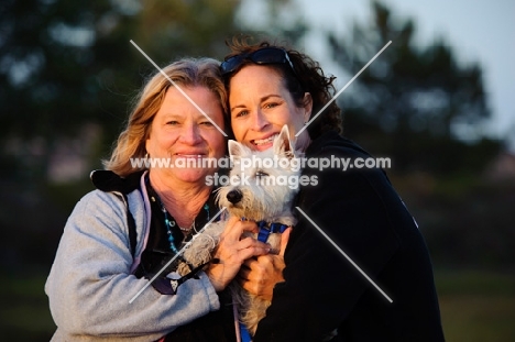 two women and a West Highland White Terrier