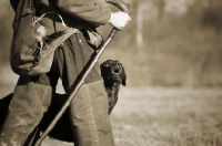 Picture of black labrador looking up at owner while walking