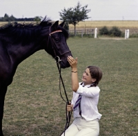 Picture of child patting her pony on the nose