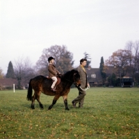 Picture of child riding pony being led on leading rein