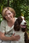 Picture of English Springer Spaniel and woman with greenery background