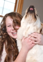 Picture of girl embraces her Labrador