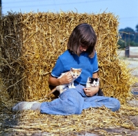 Picture of girl holding two kittens
