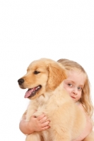 Picture of girl hugging her puppy on wooden floor