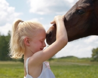 Picture of girl hugging young Appaloosa horse
