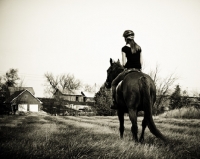 Picture of girl riding Thoroughbred in field