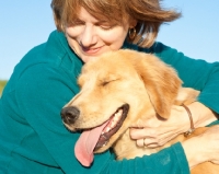 Picture of Golden Retriever being held by a woman