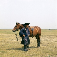 Picture of Hungarian Horse with csikÃ³, traditional clothes, girthless saddle, on great Hungarian Plain 