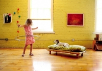 Picture of Jack Russell Terrier looking at girl who's playing with a hula hoop