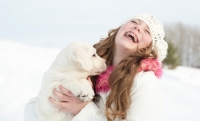Picture of Labrador puppy with girl, in winter