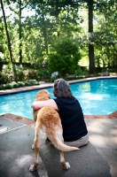 Picture of Labrador Retriever with woman near pool