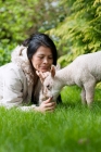 Picture of lamb eating from owner's hand.