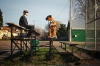 Picture of Man and Boxer on bleachers