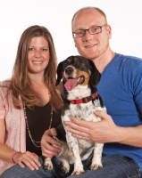 Picture of man and woman with their Dachshund x Beagle mix (also known as Doxle, Doxie, Beaschund)