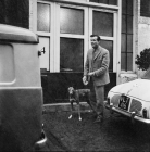 Picture of man with a greyhound in a cobbled street