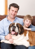 Picture of mand and boy with a Saint Bernard