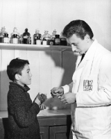 Picture of PDSA dispensary at Walthamstow. Boy with guinea pig at vet surgery.