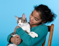 Picture of tabby and white cat with girl