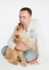 Picture of Wheaten Terrier sitting on owner's lap.