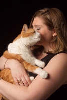 Picture of woman cuddling red and white cat
