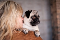 Picture of woman holding fawn Pug
