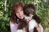 Picture of woman hugging her young Portuguese Water Dog