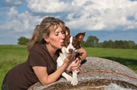 Picture of woman kissing her Border Collie