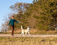 Picture of woman walking her Husky