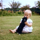 Picture of young child cuddling a long coat chihuahua