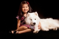 Picture of young Samoyed with young girl